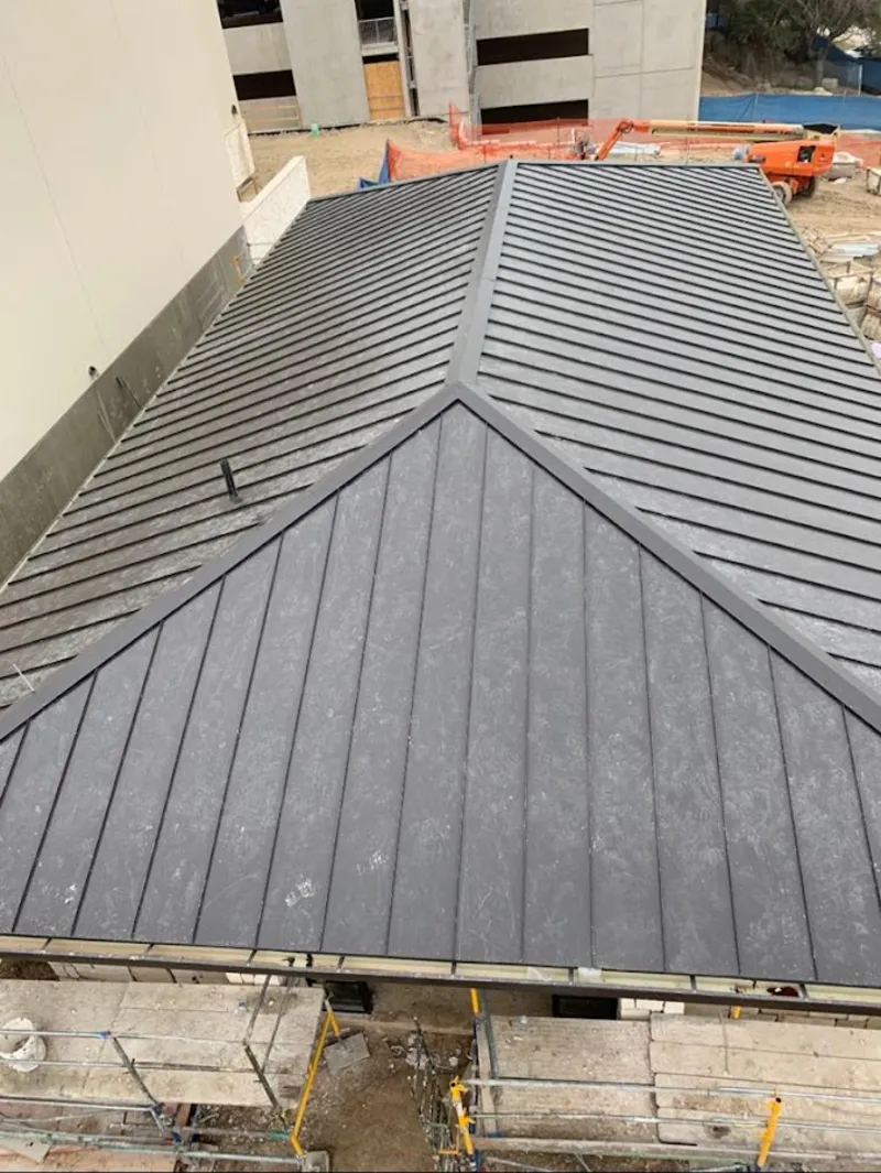 Commercial metal roof construction with crane equipment in Edgewood