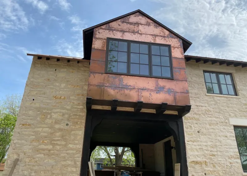 Copper metal panel facade on a stone building for Skylight Installation in Edgewood